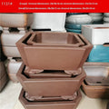 Two brown square stump purple sand flowerpots on a desktop with green plants