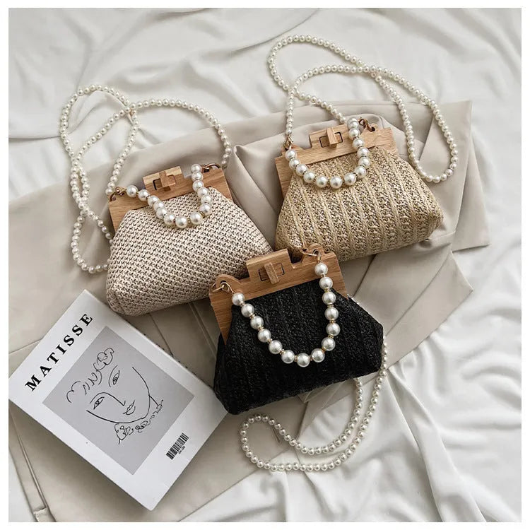 Women's woven straw shoulder bag with pearl chain detail in beige colour, showing interior organiser pockets.