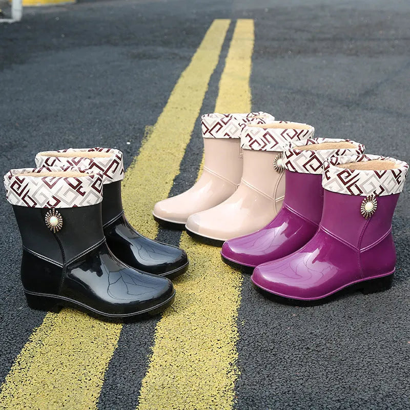 Women's mid-calf rain boot in purple PVC with a non-slip sole and low tube design.