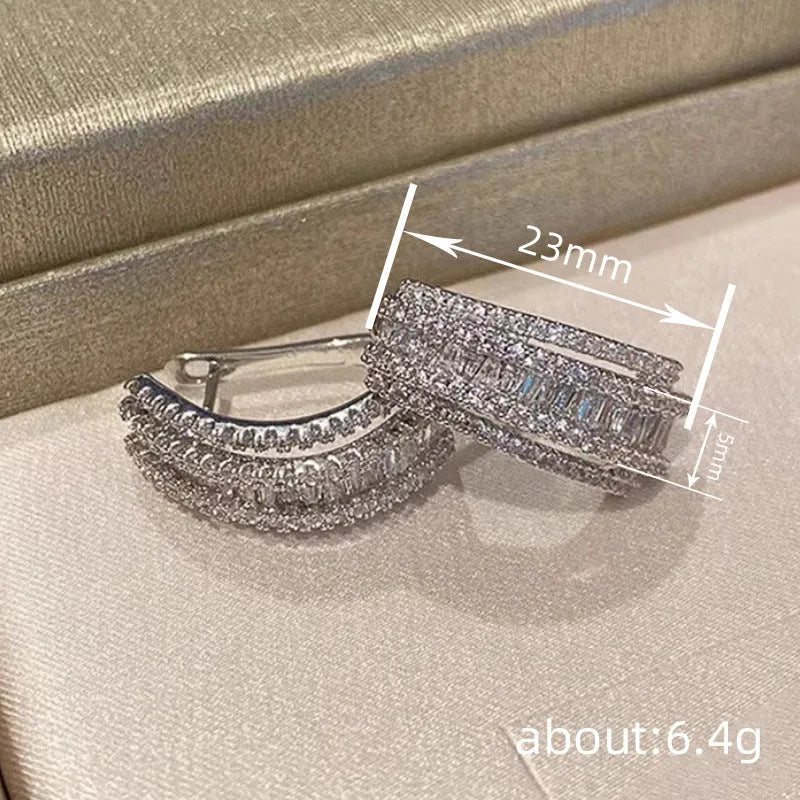 Geometric copper stud earrings with inlaid zircon stones in white gold colour finish.