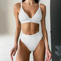 Grey women's bikini set with contrast binding and embroidery on the top and shorts.