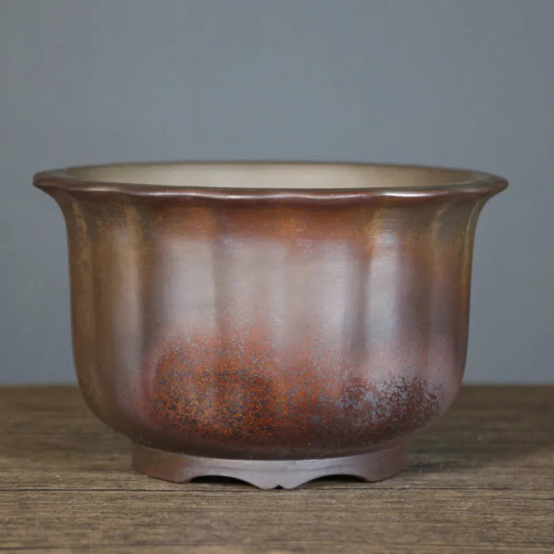 Indoor antique carved ceramic flower pot in purple sand clay with old pile texture
