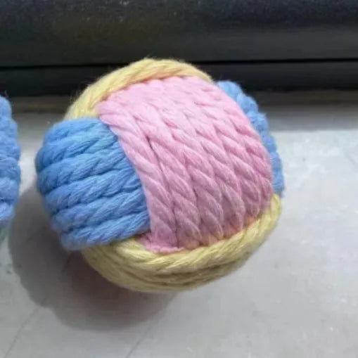 Handmade cotton plush cat toy in blue pink green colours measuring 5cm diameter