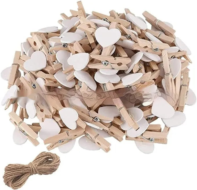 Five small solid wood heart-shaped clips in different colours showing handmade craft details