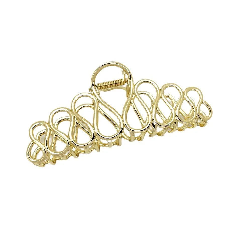 Large alloy hair clip with gold electroplated finish and irregular tassel detail