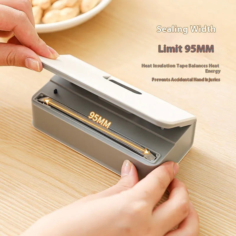 Small white portable heat sealing machine for plastic food bags with hand-press mechanism