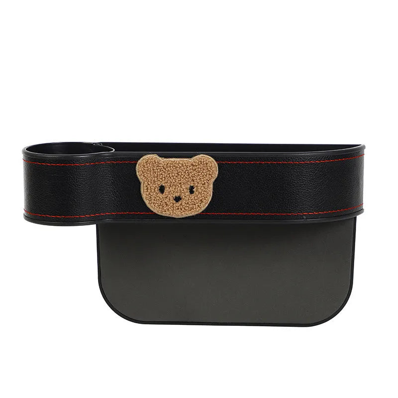 PU leather car seat gap storage box hanging between vehicle seats for small item organisation.