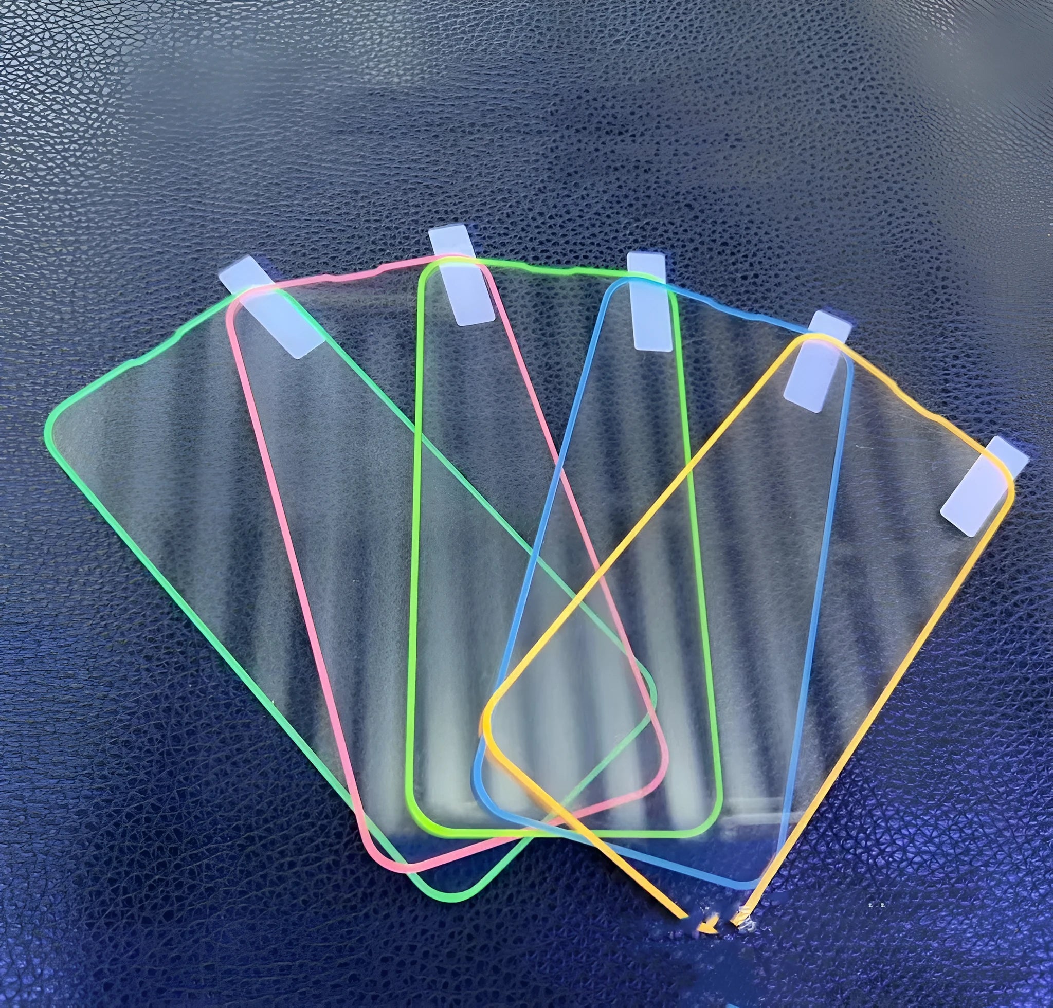 Fluorescent tempered glass screen protector for iPhone showing luminous pink, yellow, green, blue and grass green colour options.