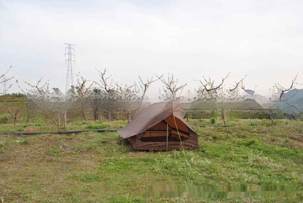 Brown A-line cabin tent pitched with hiking poles as structural support showing spacious interior for 2-3 people