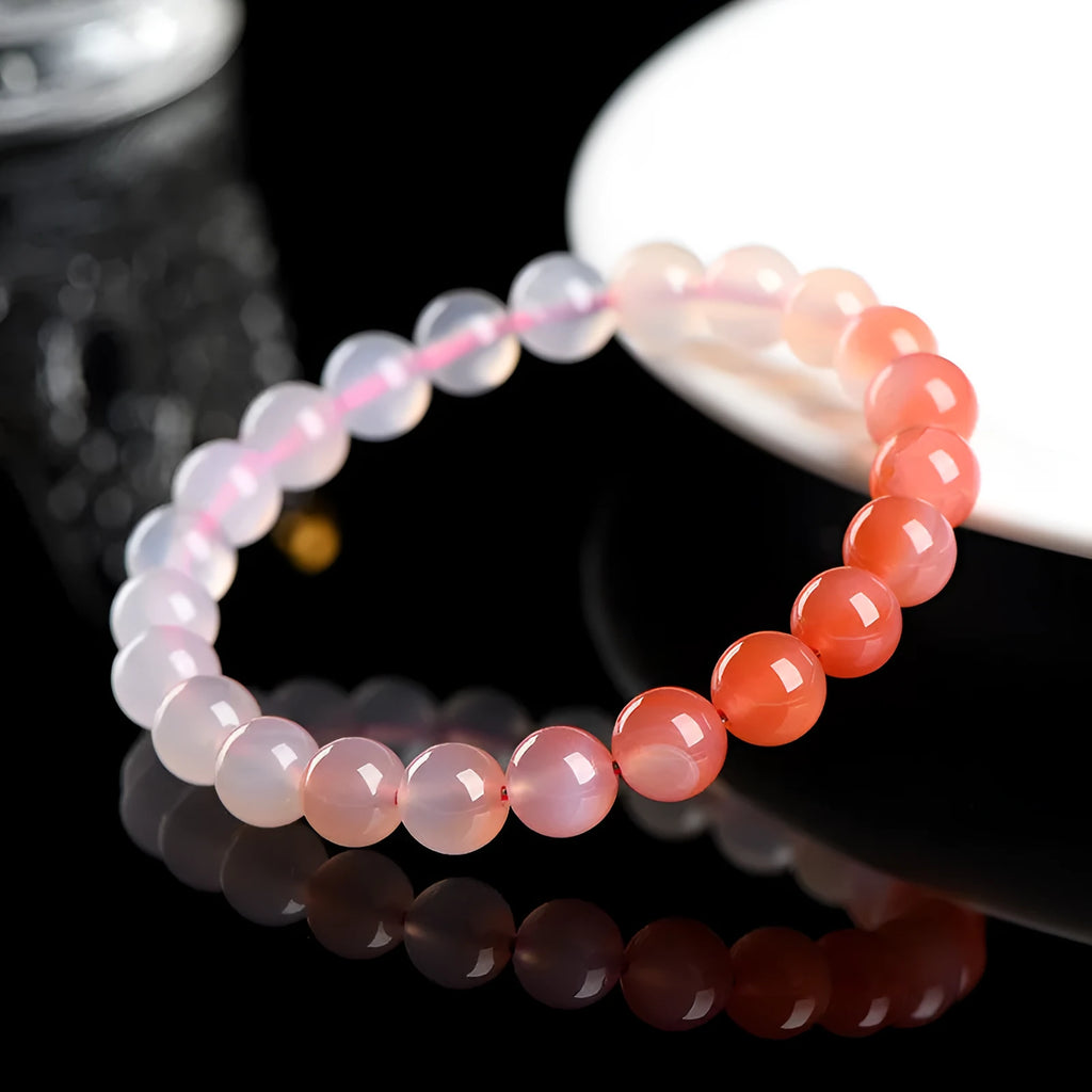 Natural gradient Yanyuan agate bracelet with geometric beads in salt source colour on a wrist.