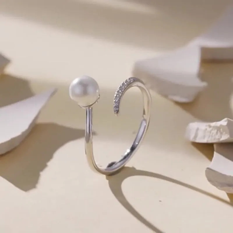 Sterling silver adjustable pearl ring with natural shell pearls on open loop design
