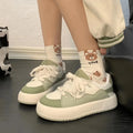 Green women's flat casual sneakers with a round toe and breathable PU mesh upper.
