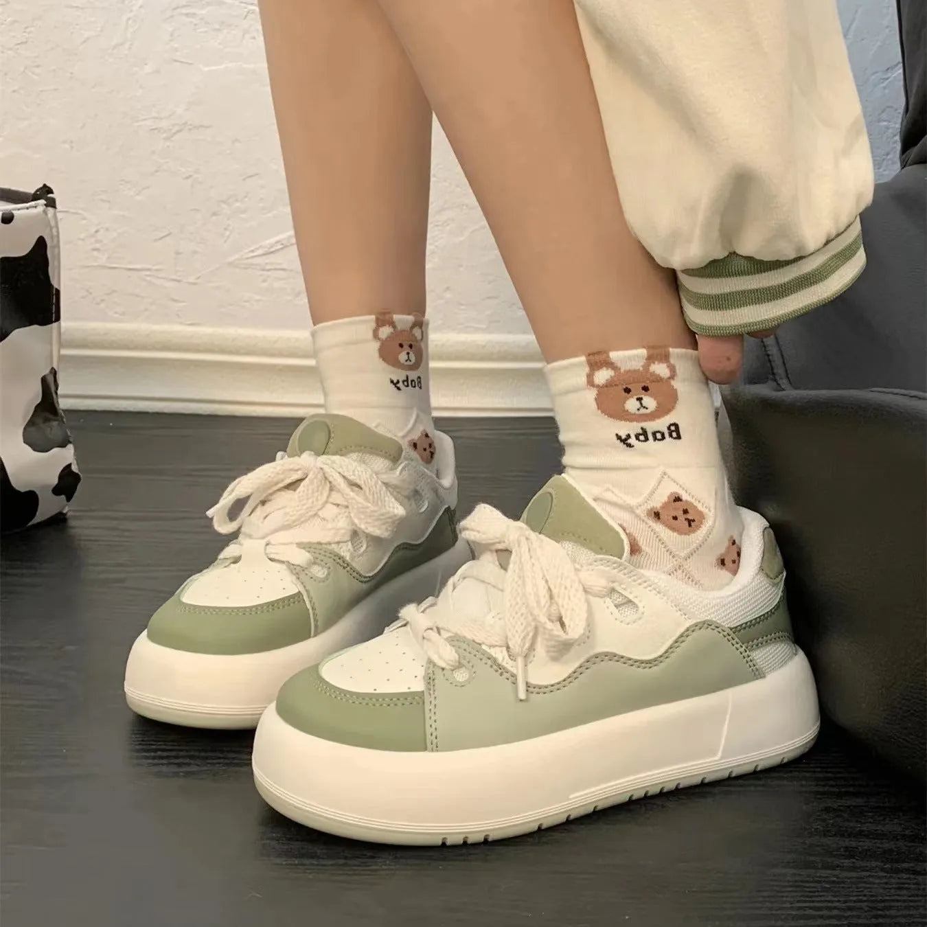 Green women's flat casual sneakers with a round toe and breathable PU mesh upper.