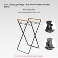 Black folding iron outdoor trash rack with a wooden handle standing upright.