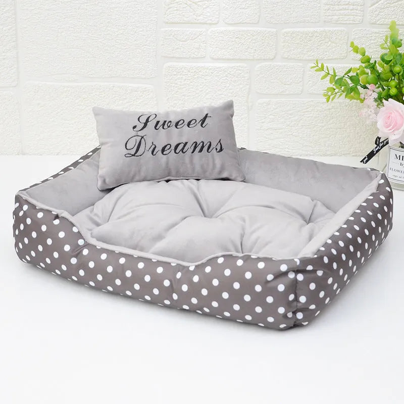 Polka dot print dog bed with a matching square pillow in grey, blue, pink, or red.