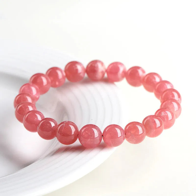 Women's geometric crystal bracelet with natural red patterned stone beads and longevity lock design element