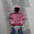 Man wearing a blue loose-fit hooded zip coat with digital print, long sleeves, for casual autumn wear.