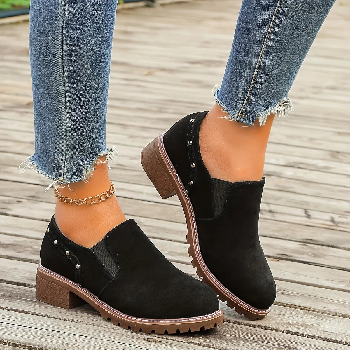 Women's light brown suede ankle boots with a thick low heel and elastic band fastening.