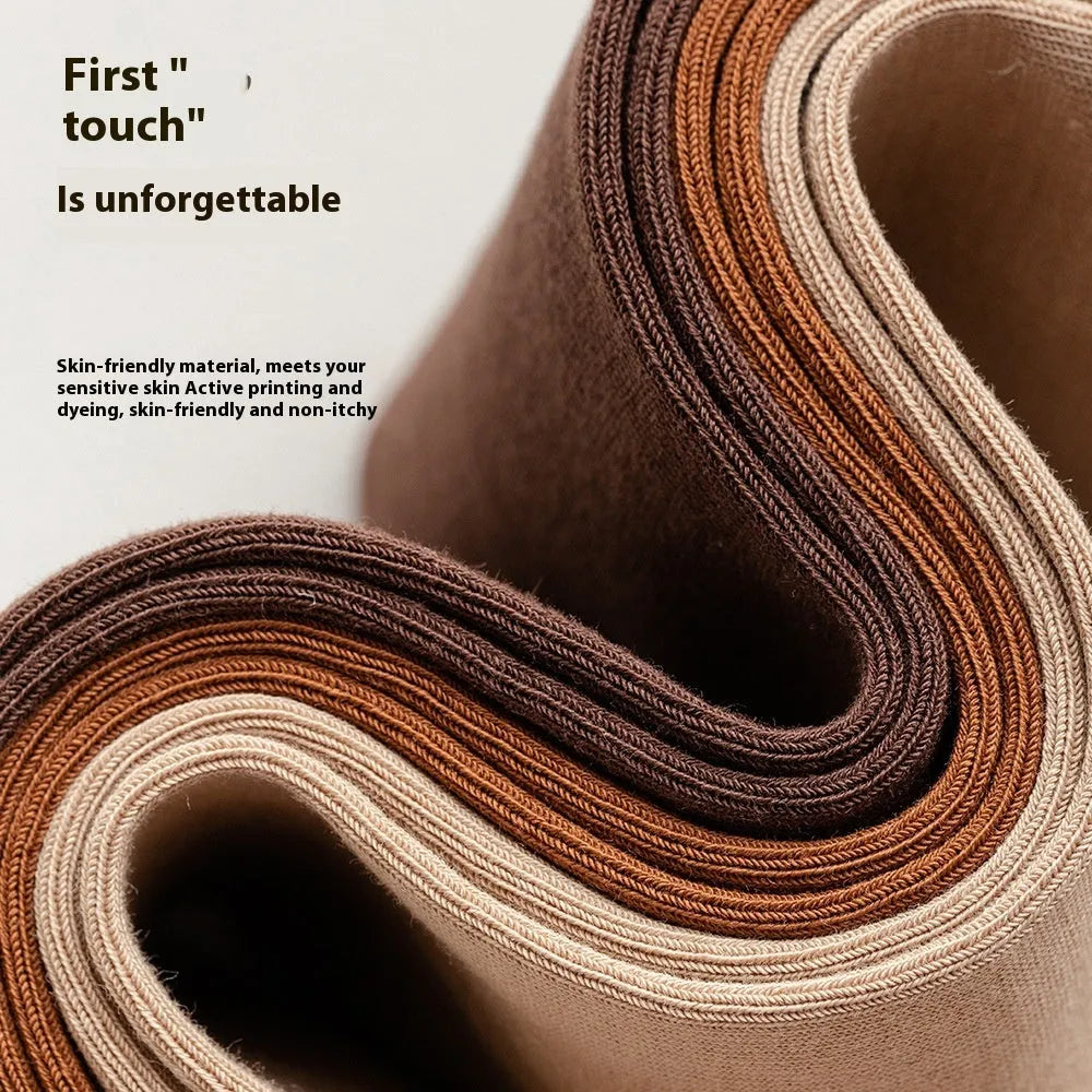 Mid-calf men's socks in solid colours made from combed cotton, shown in a stack.