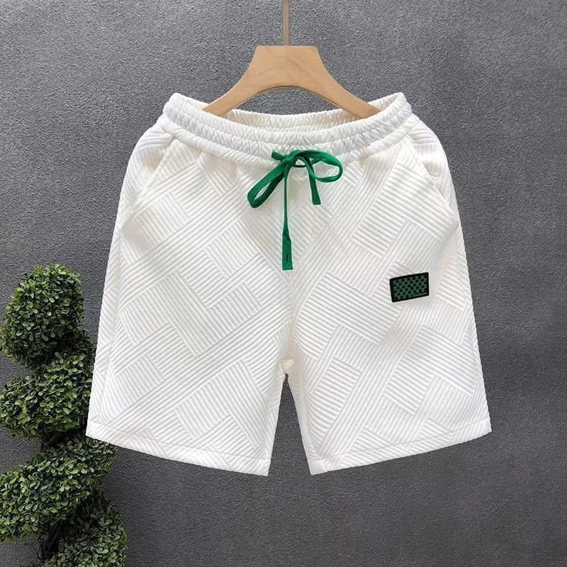 Casual solid colour sports shorts made from elastic polyester fabric.