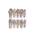False nail patches with large rhinestones on card, shown with jelly adhesive pot and nail tools.