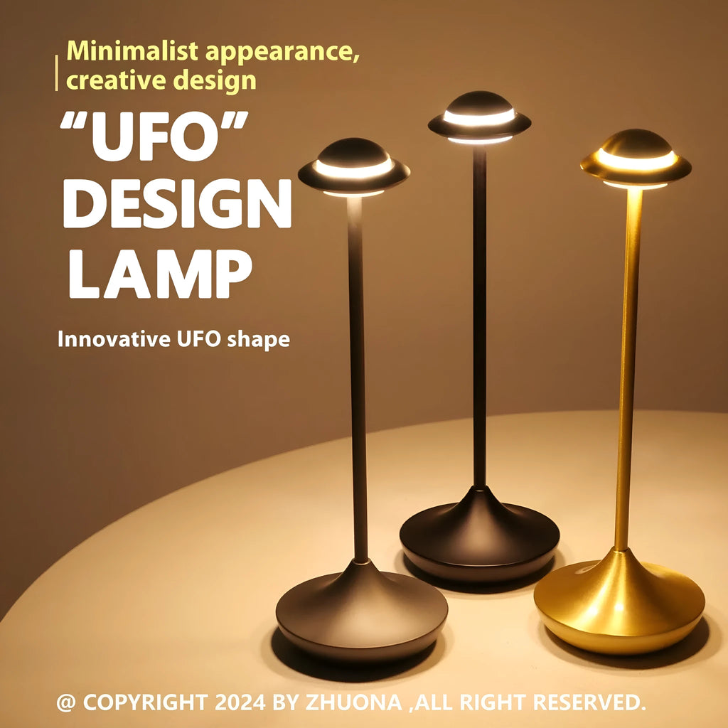 UFO-shaped table lamp with metallic finish and touch controls on desk surface