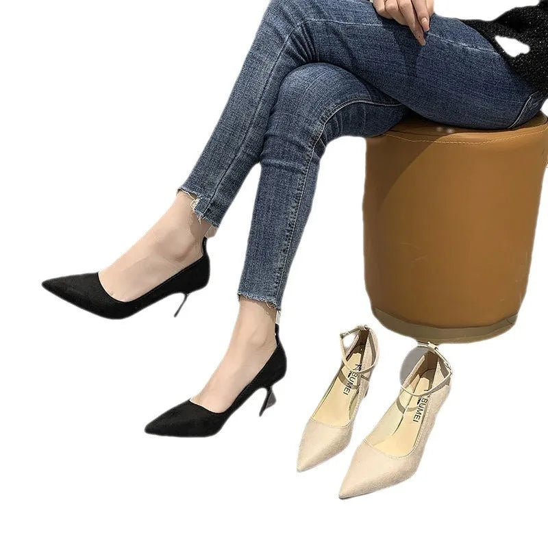 Black women's stiletto heel pump shoes with a skull pattern and ankle buckle on a rubber sole.