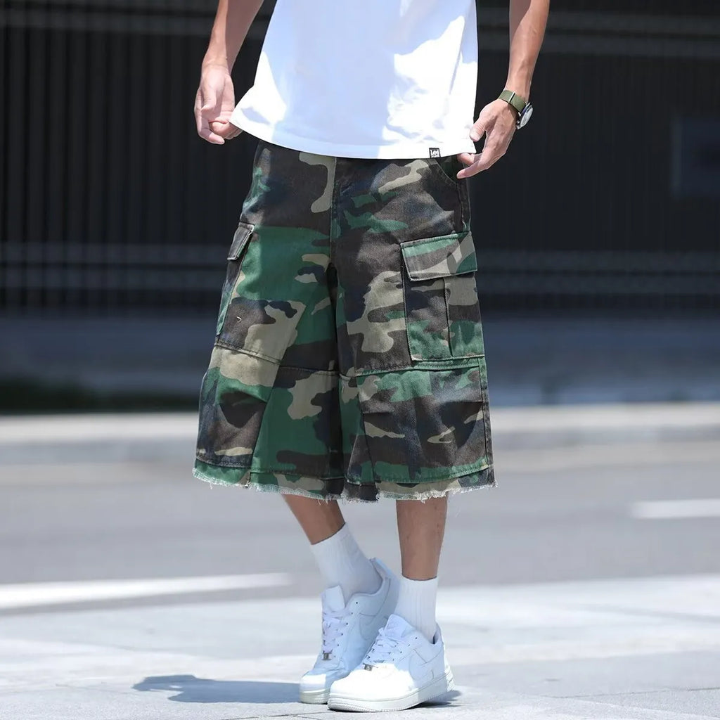 Men's loose-fit camouflage print shorts in retro workwear style on a white background.