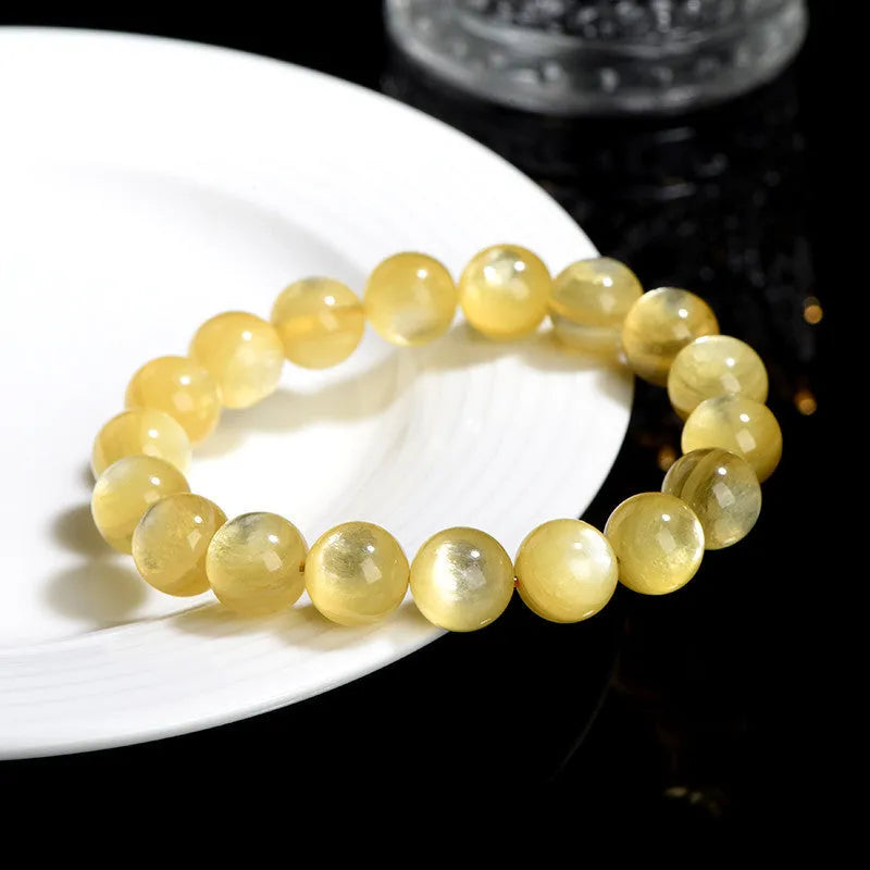 Yellow Lepidolite mica stone bead bracelet with round geometric design on wrist