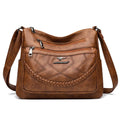 Soft PU leather shoulder bag in horizontal square shape, shown in one of four colours with crossbody strap