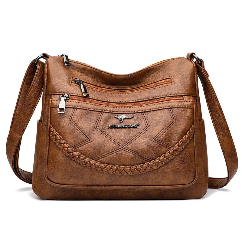 Soft PU leather shoulder bag in horizontal square shape, shown in one of four colours with crossbody strap
