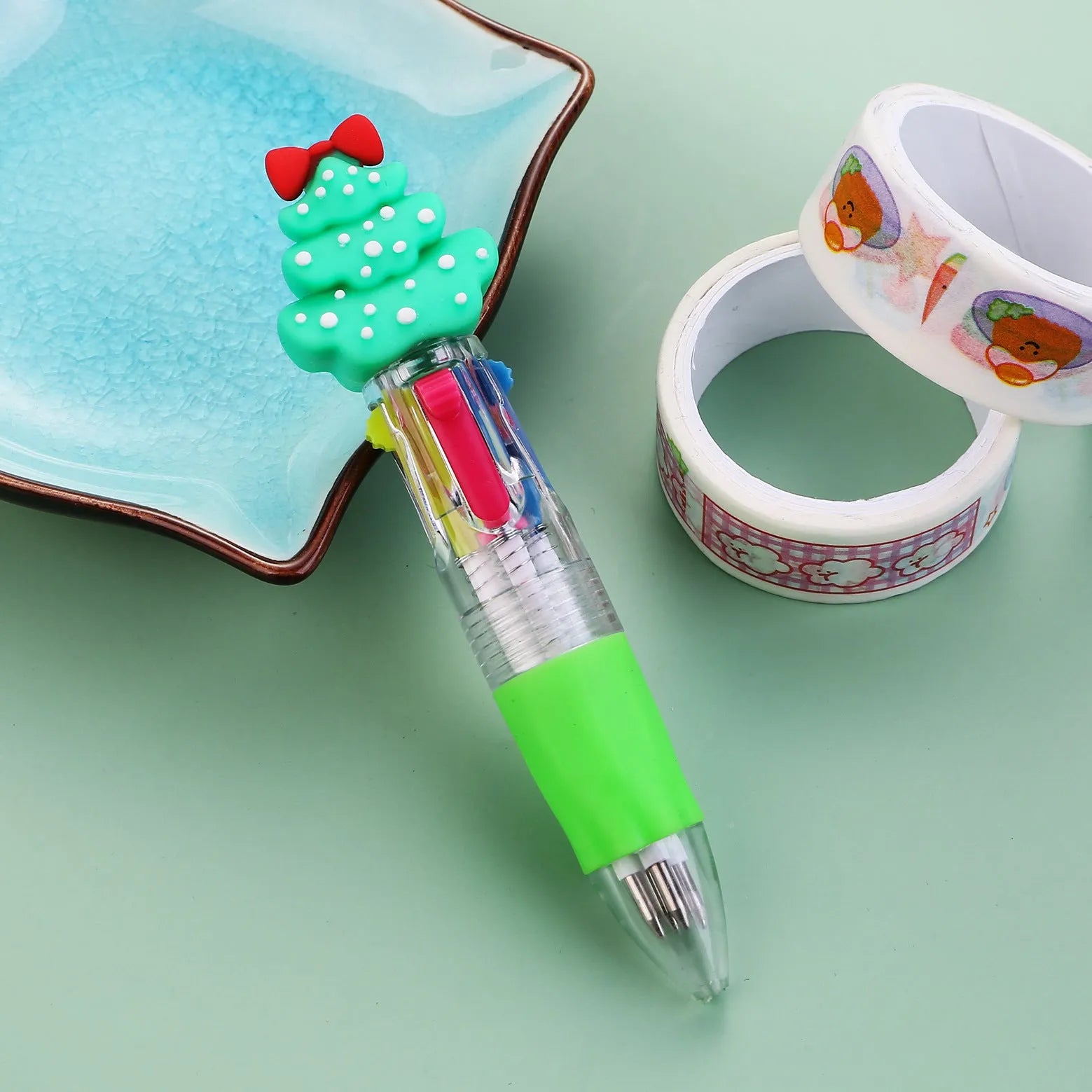 Compact 11cm Christmas four-colour press pen with festive designs including reindeer and snowmen.