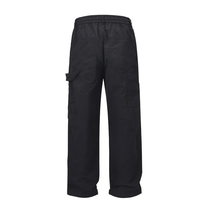 Black paratrooper pants with elastic drawstring waist and three-dimensional baggy cut