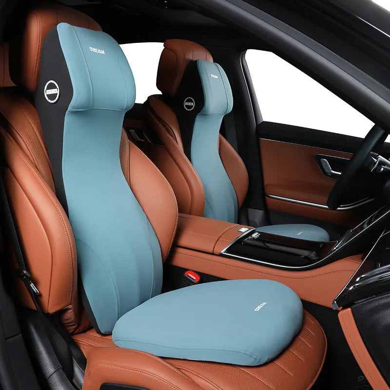 Integrated automotive memory foam seat cushion and headrest lumbar support pillow in various colours.