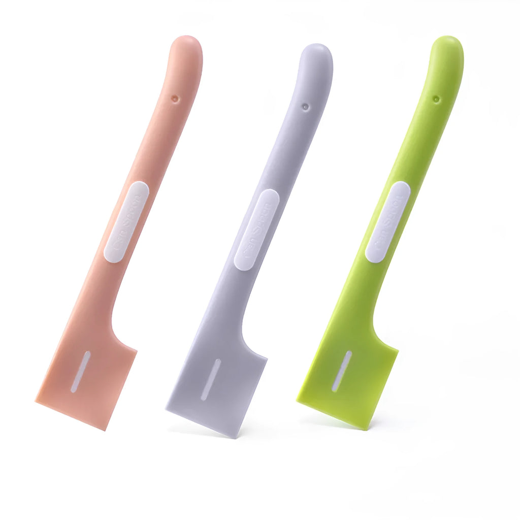 Green long-handle pet feeding spoon for canned cat and dog food on a white background.