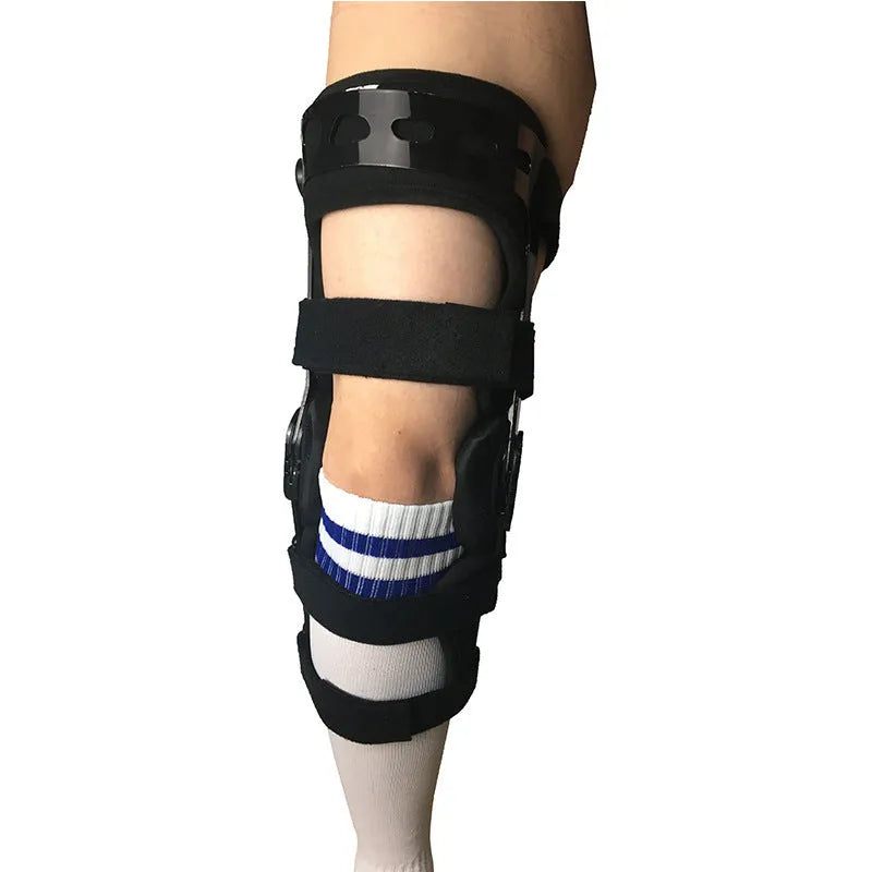 Black adjustable anterior ligament knee support with straps, shown on a leg.
