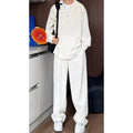 Men's black casual hemp polo shirt and trousers two-piece suit set on a hanger.