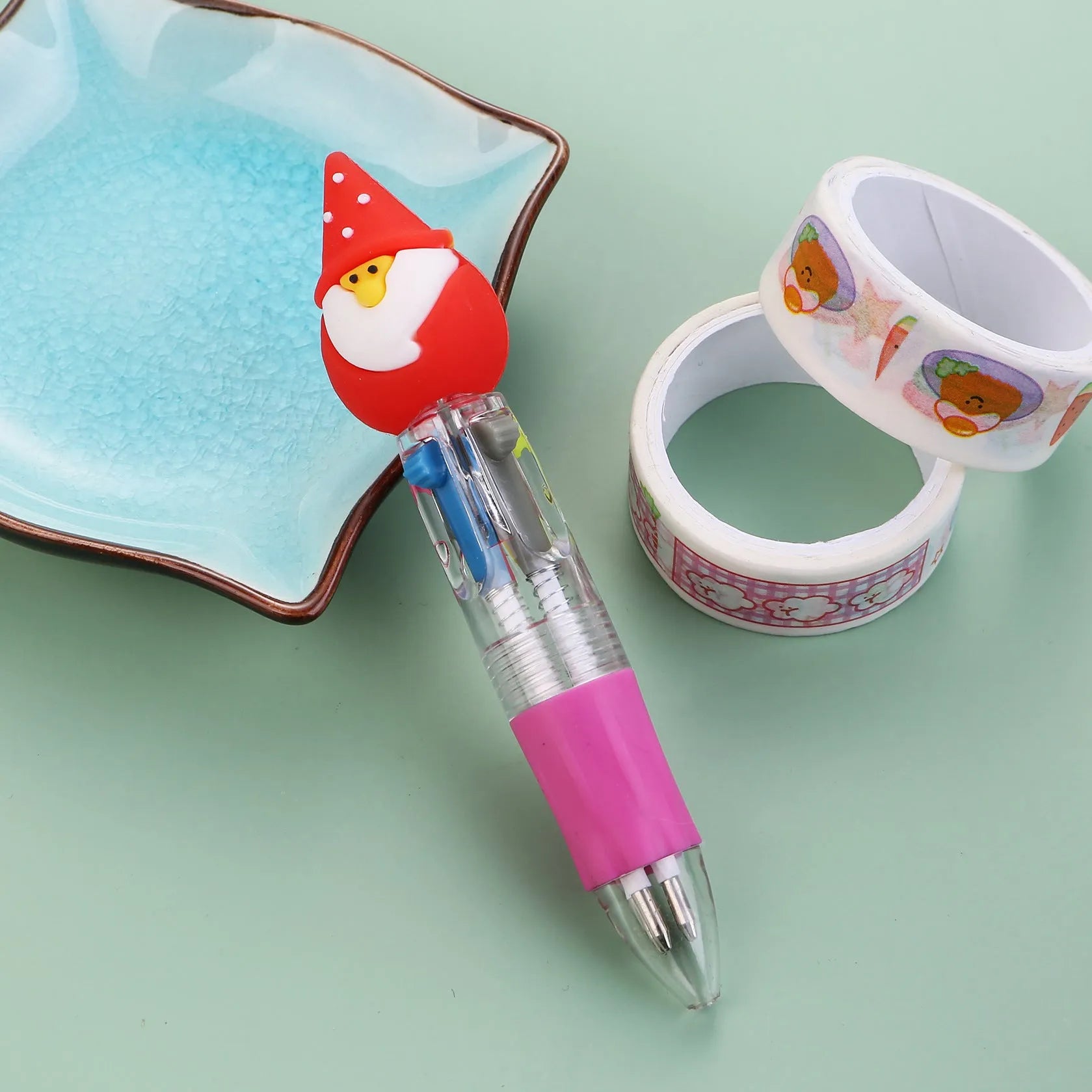 Compact 11cm Christmas four-colour press pen with festive designs including reindeer and snowmen.