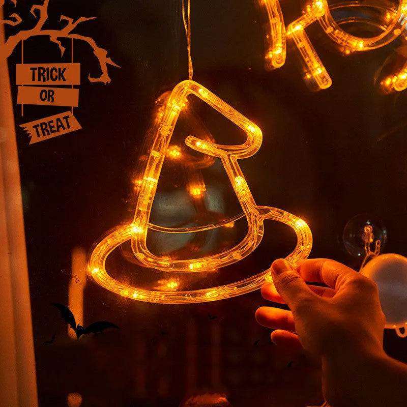 Set of seven battery-powered Halloween LED hanging lights with ghost, spider, and pumpkin designs for window decoration.