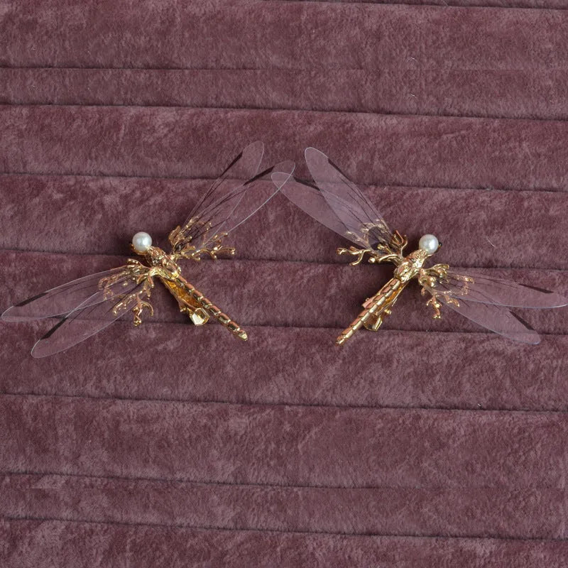 Golden dragonfly-shaped metal alloy headdress with a side clip for hair.