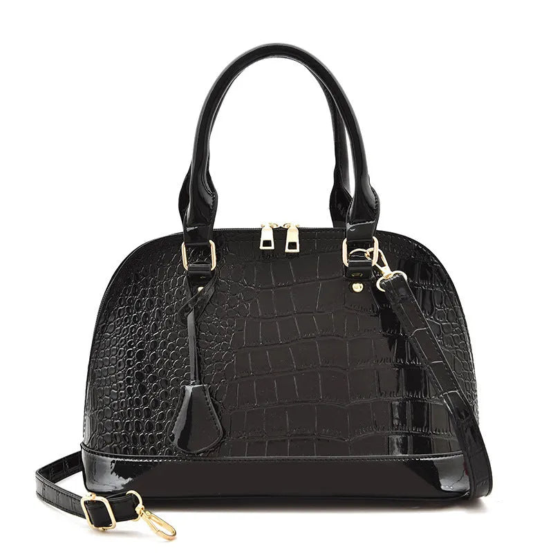 Shiny black PU leather shell-shaped crossbody bag showing its structured design and size.