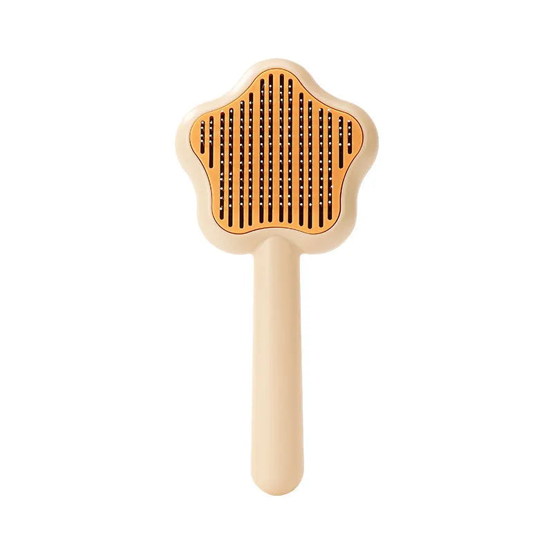 Green self-cleaning cat comb with stainless steel needle pins on a white background
