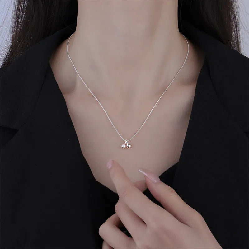 Sterling silver cherry pendant necklace on a snake bone chain, adjustable from 21cm to 50cm.