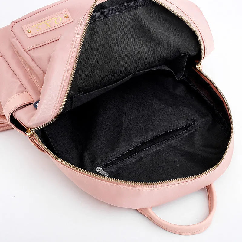 Women's black nylon casual backpack with waterproof construction and anti-theft compartments