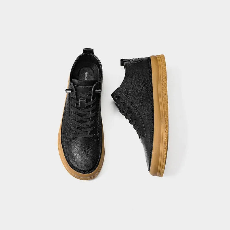 Men's black leather casual shoes with white stitching and lace closure on a white rubber sole