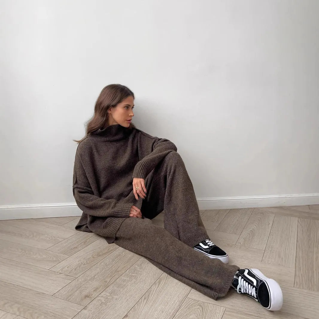 Women's acrylic suit set showing side-slit sweater top with matching trousers in solid colour