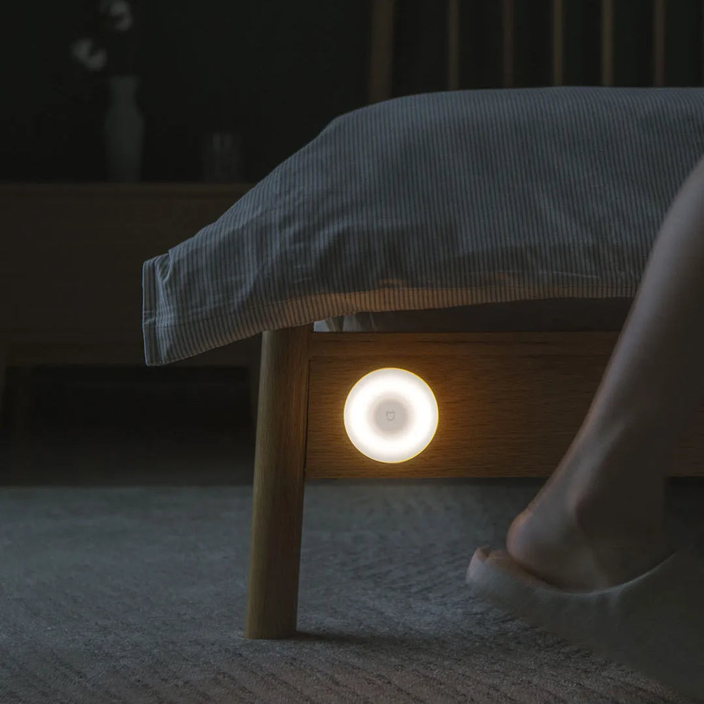 White Mijia Bluetooth bedside night light with human body induction on a wooden table.