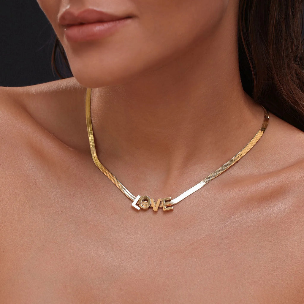 Gold titanium steel necklace with a letter A charm on a 40.5cm chain.