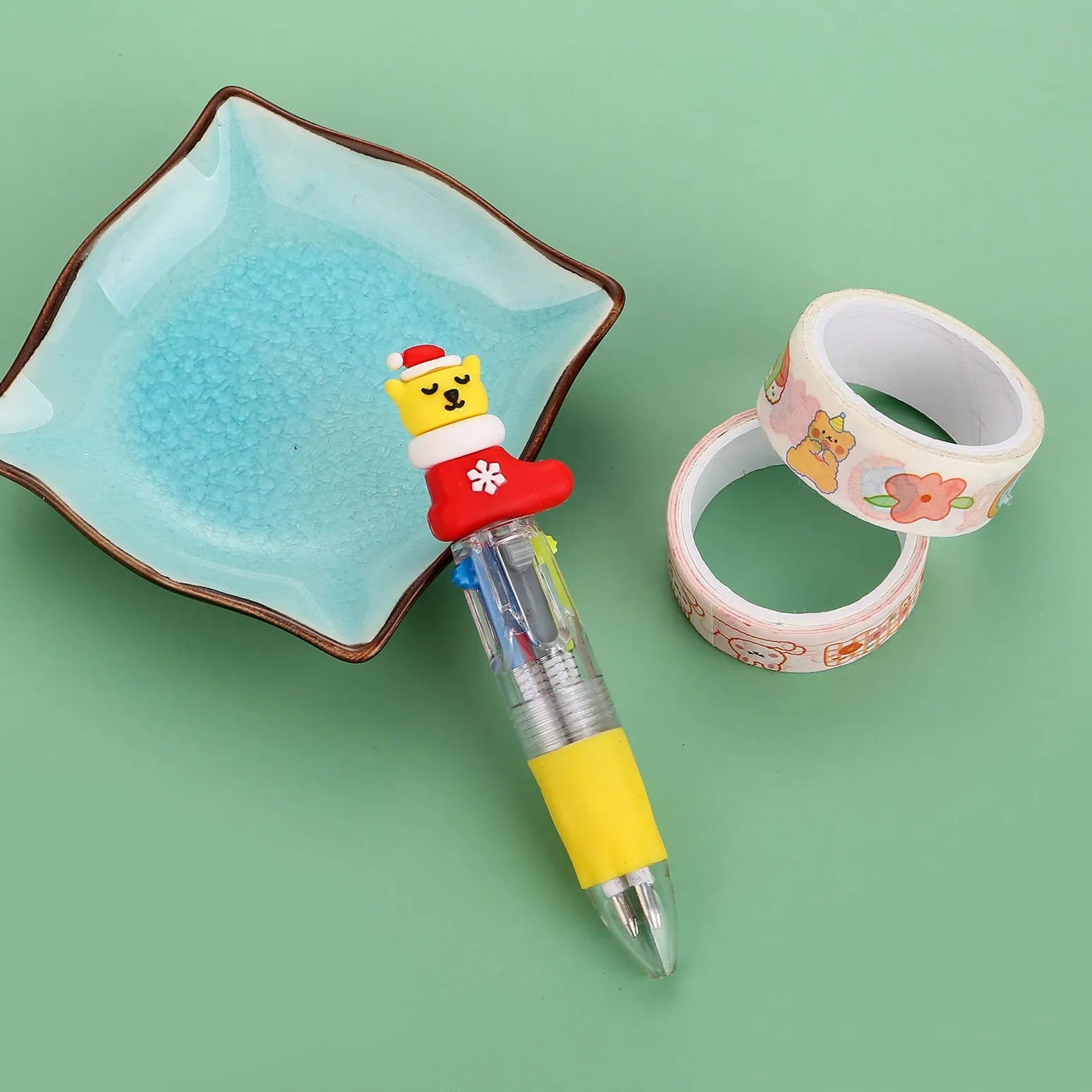 Compact 11cm Christmas four-colour press pen with festive designs including reindeer and snowmen.