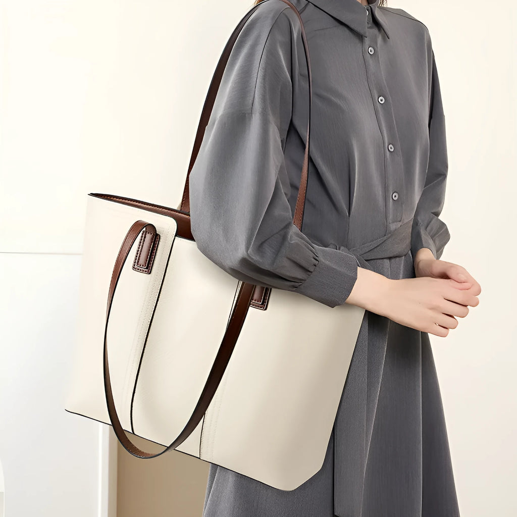 Women's black horizontal square leather commuter shoulder bag with crossbody strap and internal organiser pockets.